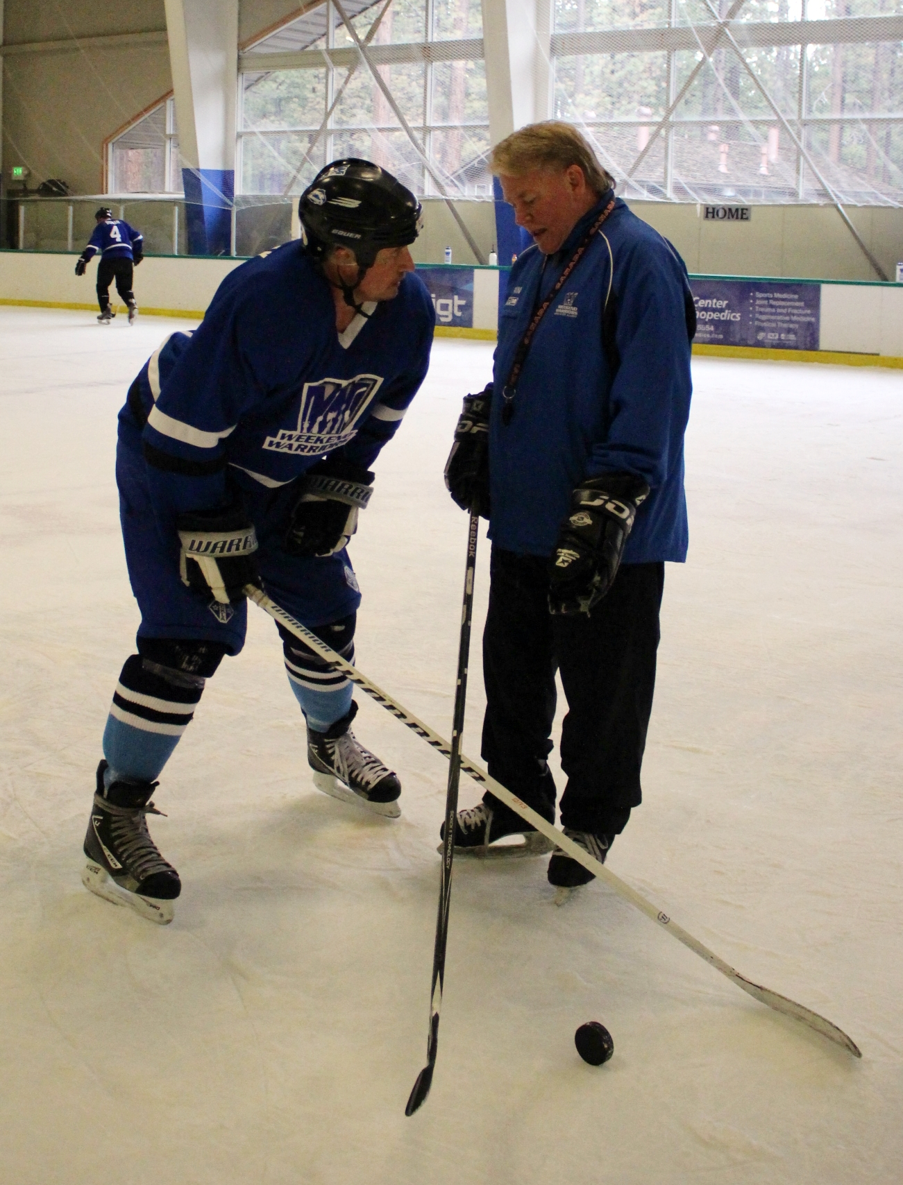 Coach Kevin helps player with wrist shot