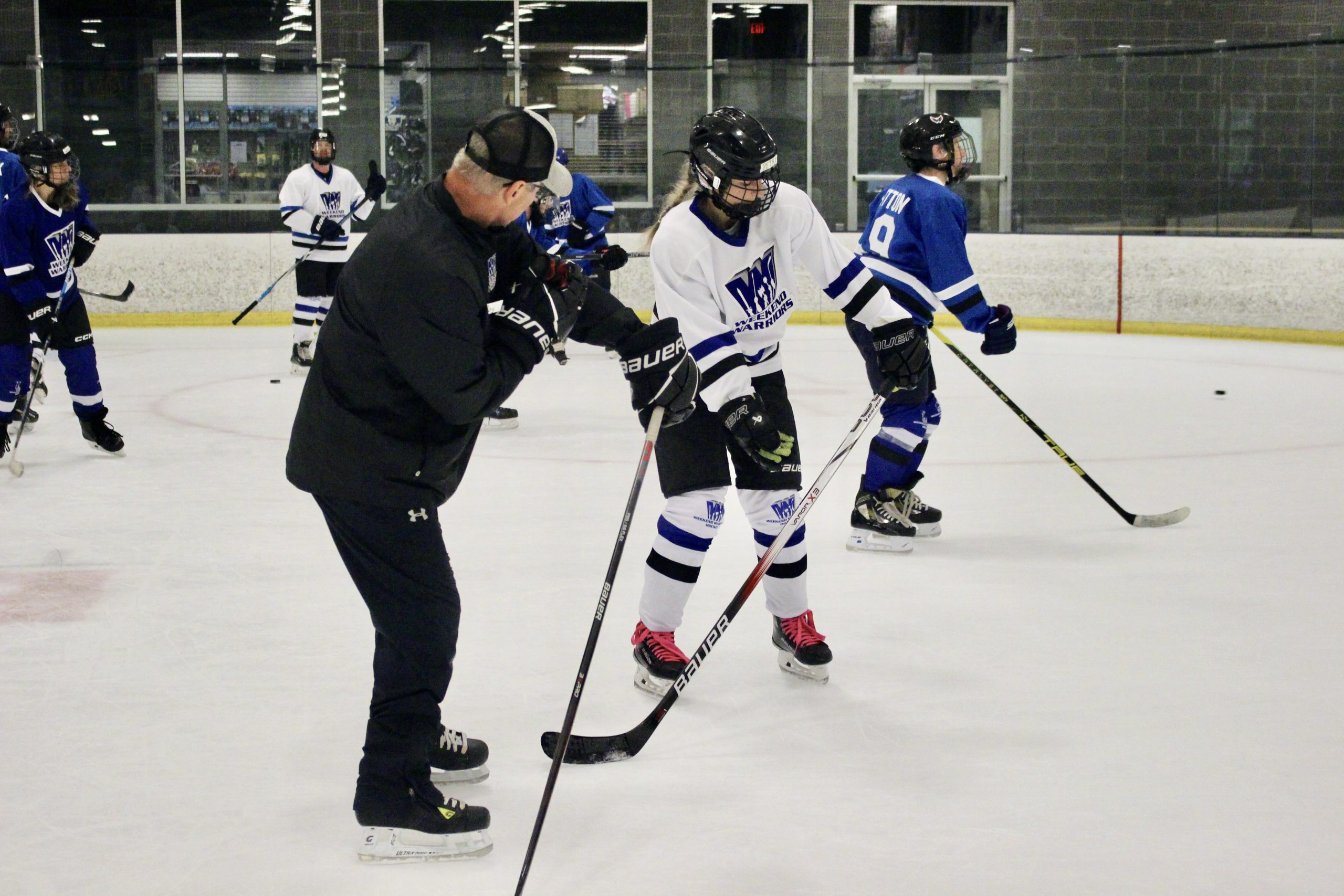 Coach Casey with player Coach Casey helps a player with shooting